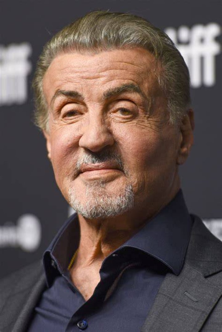 Sylvester Stallone attending a movie screening while wearing a suit.