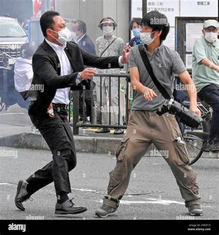 Tetsuya Yamagami, 41, a veteran of Japan's armed forces, was tackled by security (pictured) and then arrested on suspicion of attempted murder