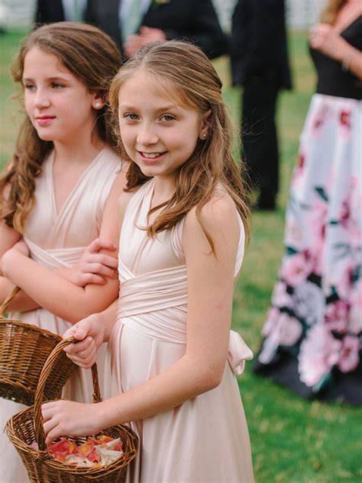 The flower girls, including Harper Beckham (pictured at center) are seen after the wedding ceremony