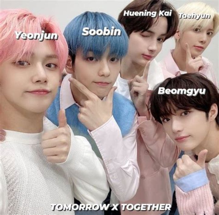 The members of TXT pose in black outfits for a 'minisode 2: Thursday's Child' concept photo