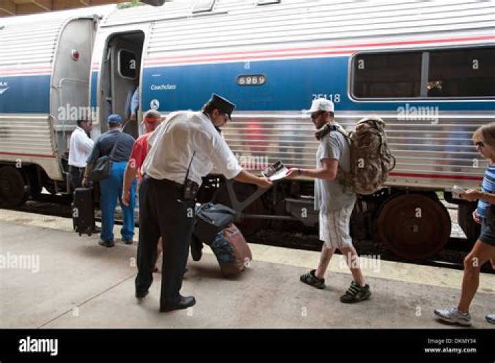 Train conductor checking passengers for tickets. | Photo: Getty Images