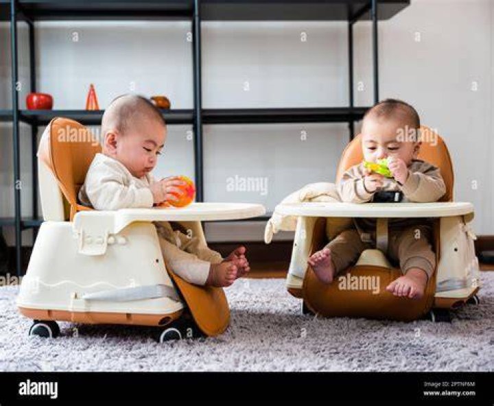 Twin babies sitting on toy cars | Source: Pexels