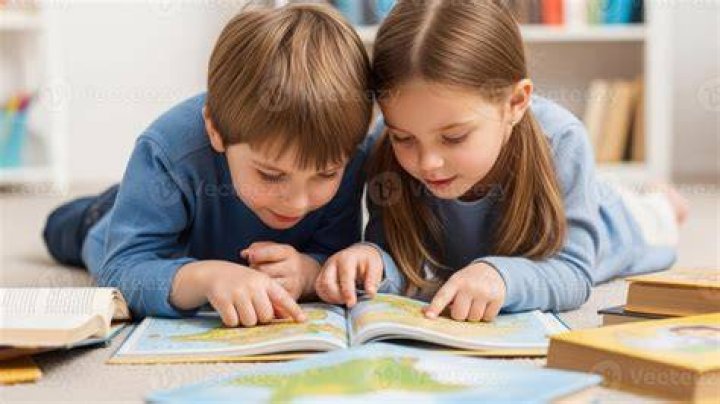 Two children reading a fairy tale book. | Photo: Pexels