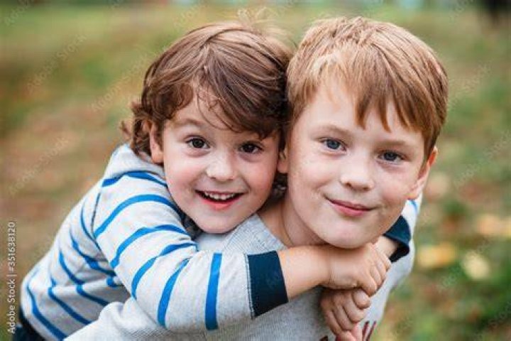 Two young brothers playing outside | Source: Shutterstock