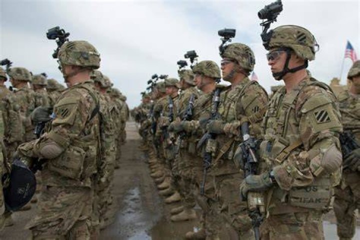US military personnel stand by a M142 High Mobility Artillery Rocket System (HIMARS) in Saudi Arabia