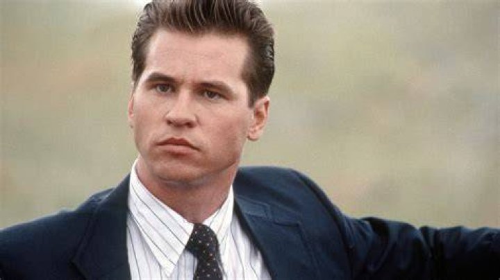 Veteran actor Val Kilmer posed beside a poster of his 2012 show in California. | Photo: Getty Images