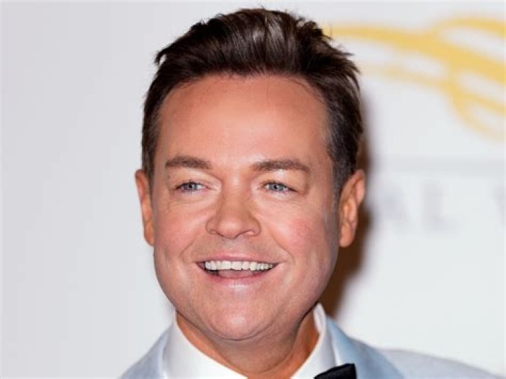 Wedding bells: Stephen Mulhern waved to onlookers as he arrived in a light blue suit and navy tie