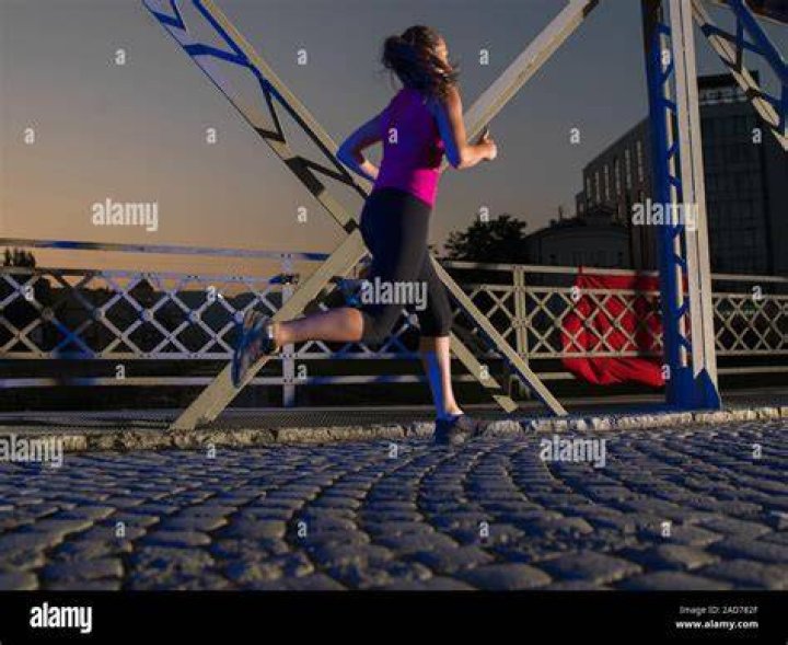 woman jogging on bridge