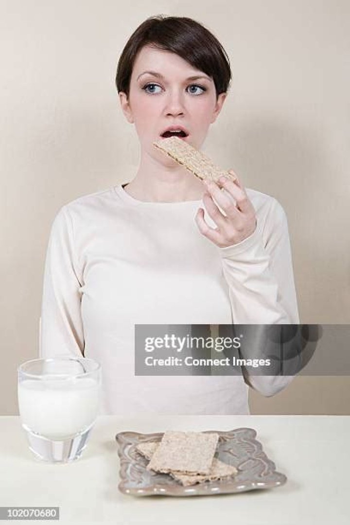 Woman Snacks on Crackers
