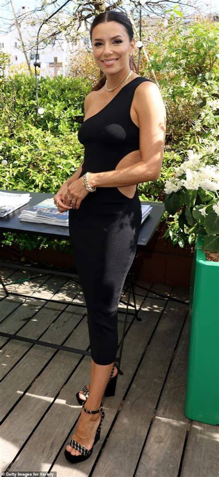 Wow! Eva showed off her ample assets in a clinging black gown as she laughed and joked with her pals at the wedding