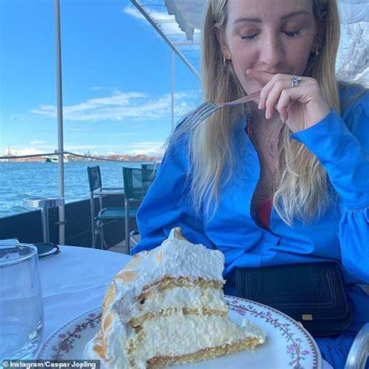 Yum: Clearly besotted, Caspar shared a snap of Ellie caught off-guard indulging in cake