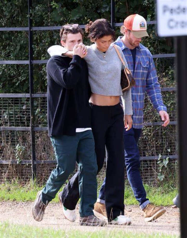 Zendaya and Tom Holland kissing in his car.
